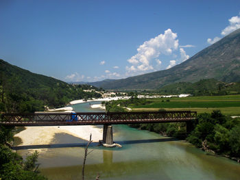 View of swimming pool by mountains against sky