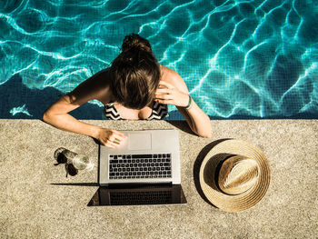 High angle view of woman using mobile phone in swimming pool