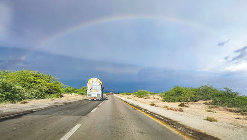 People walking on road against sky