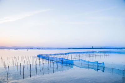 Scenic view of lake against sky during winter