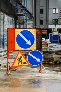 Road signs against buildings in city