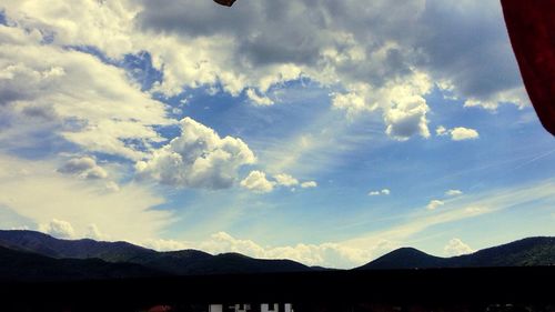 Scenic view of mountains against cloudy sky