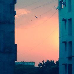 Low angle view of built structure against sky at sunset