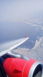 Aerial view of airplane flying over sea