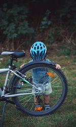 Bicycle and little boy on field