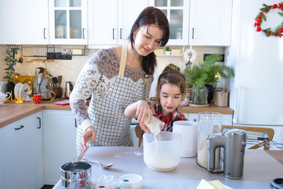 Side view of woman preparing food at home