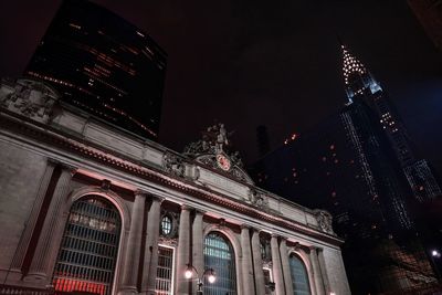 Low angle view of illuminated building against sky at night