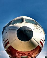 Low angle view of airplane against blue sky