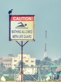 Close-up of road sign against clear sky