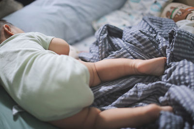 Cute baby lying on bed at home