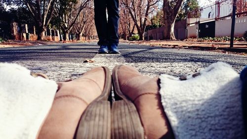 Low section of woman standing on tree trunk