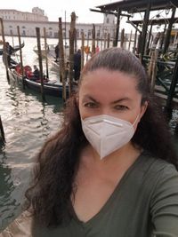 Portrait of woman in boat against canal