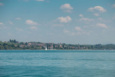 Scenic view of sea and buildings against sky