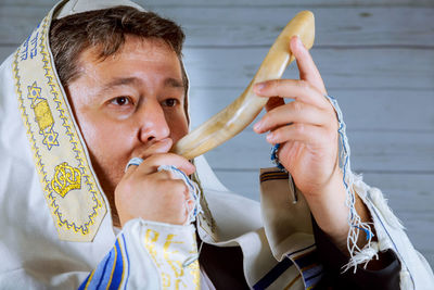 Close-up of man playing shofar