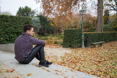 Man sitting in park during autumn