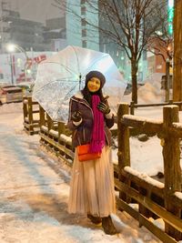 Portrait of woman standing in snow