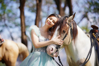 Portrait of young woman with horse