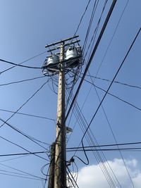 Low angle view of electricity pylon against clear sky