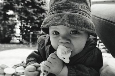 Portrait of cute boy holding hat