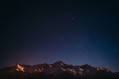 Scenic view of mountains against sky at night