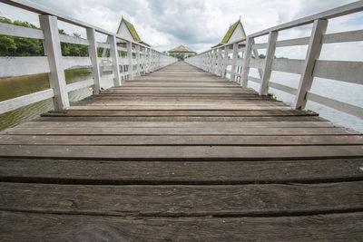 Footbridge over sea against sky