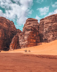 Rock formations on landscape against sky
