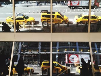 Yellow bus on road in city