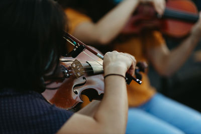 Midsection of man playing guitar