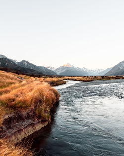 Scenic view of lake against snowcapped mountains and sky