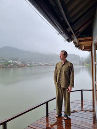 Portrait of young man standing on bridge