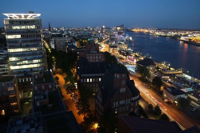 High angle view of illuminated buildings in city at night