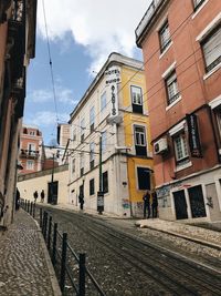 Street amidst buildings in city against sky