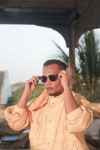 Man with sunglasses standing outdoors