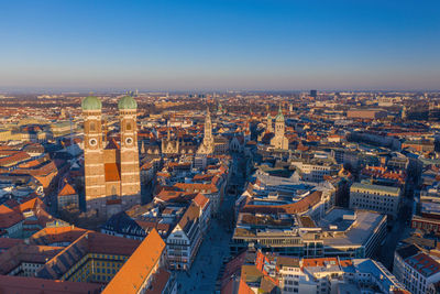 High angle view of city buildings against clear sky