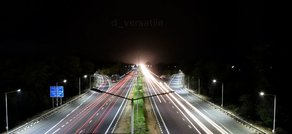 High angle view of light trails on road at night