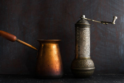 Close-up of candles on table against wall