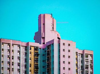 Low angle view of buildings against clear blue sky