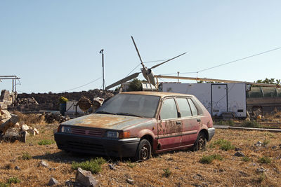 Wrecked and abandoned cars and ships in a remore location in the island