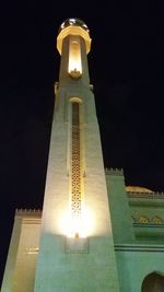 Low angle view of illuminated building against sky at night