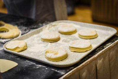 Close-up of cookie dough on tray at counter