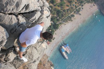 High angle view of man on rock at beach