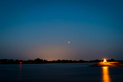 Scenic view of sea against sky at night