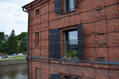 View of building by canal against sky