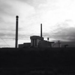 Industrial factory against cloudy sky