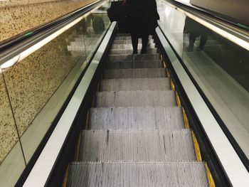 Low section of man standing on railroad station platform