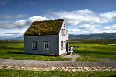 House on field against sky