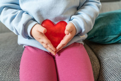 Low section of woman wearing gloves