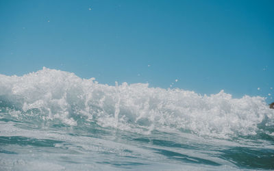 Panoramic view of sea against clear blue sky