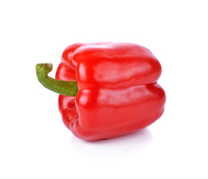 Close-up of red bell peppers against white background