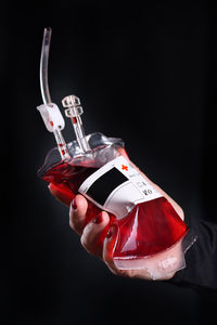 Cropped image of hand holding drink on table